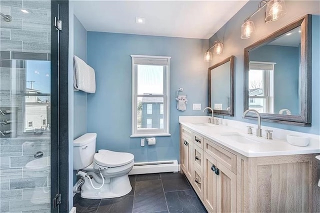 bathroom with vanity, a shower with shower door, baseboard heating, and toilet