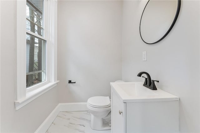 bathroom with vanity, toilet, and a wealth of natural light