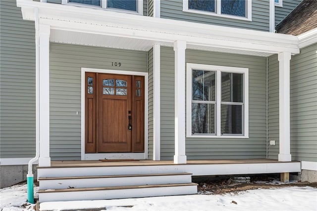 view of snow covered property entrance