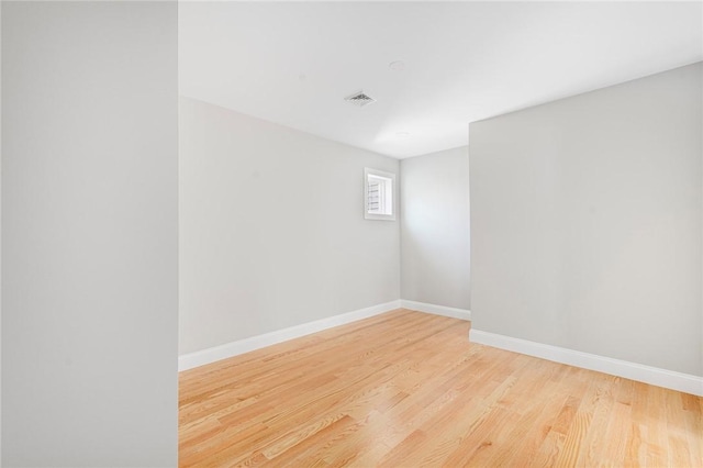 spare room with light hardwood / wood-style floors