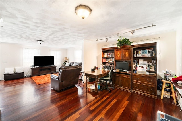 office featuring dark wood-type flooring, rail lighting, and a textured ceiling