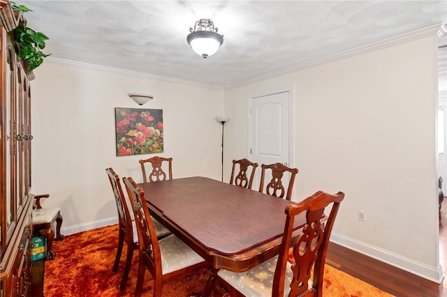 dining area featuring ornamental molding and dark hardwood / wood-style floors