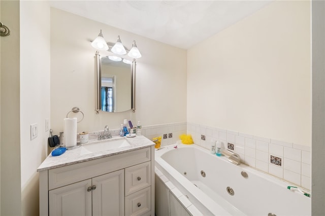 bathroom with vanity and a relaxing tiled tub