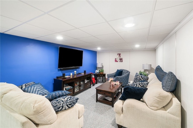 carpeted living room with a paneled ceiling