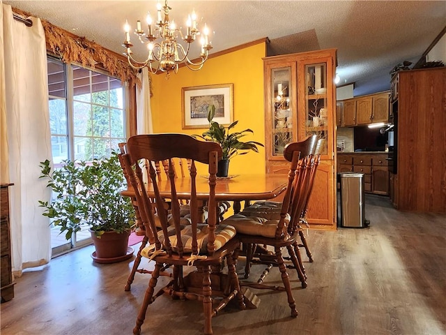 dining area with light hardwood / wood-style flooring and a textured ceiling