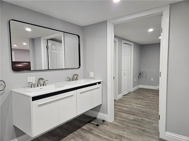 bathroom with hardwood / wood-style flooring and vanity