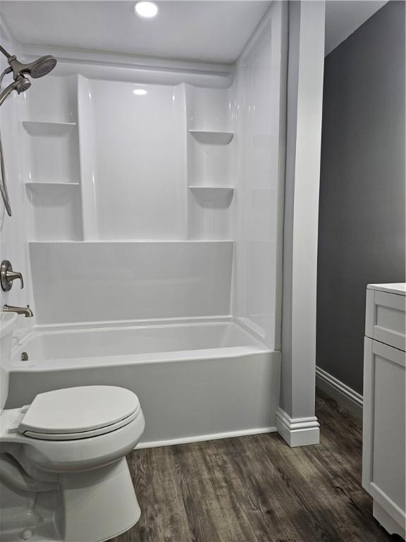 full bathroom with shower / tub combination, hardwood / wood-style floors, vanity, and toilet