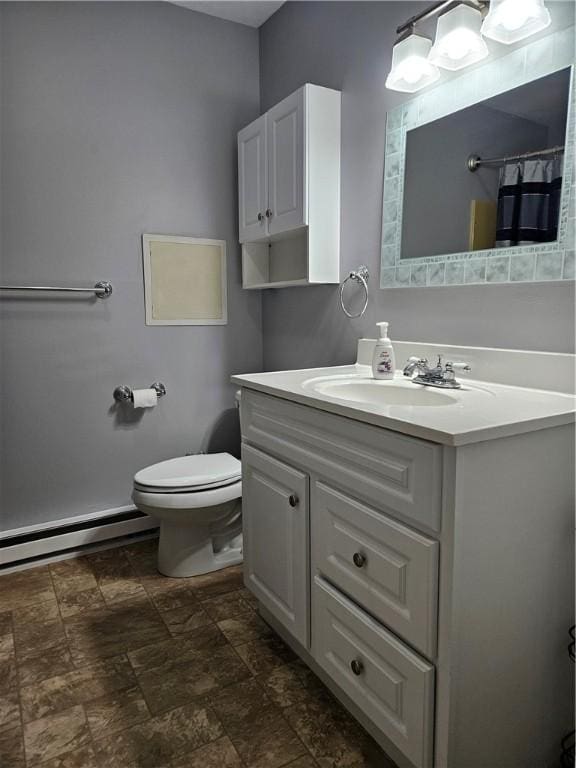 bathroom featuring vanity, a baseboard heating unit, and toilet