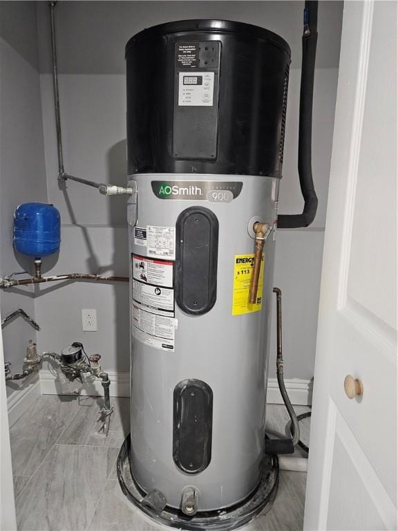 utility room featuring heat pump water heater