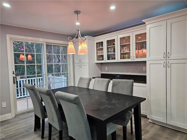 dining room with dark wood-type flooring and a chandelier