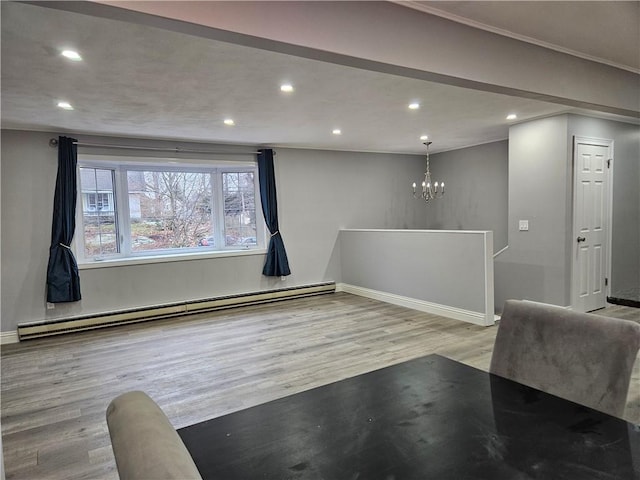 interior space featuring light wood-type flooring, a notable chandelier, and baseboard heating