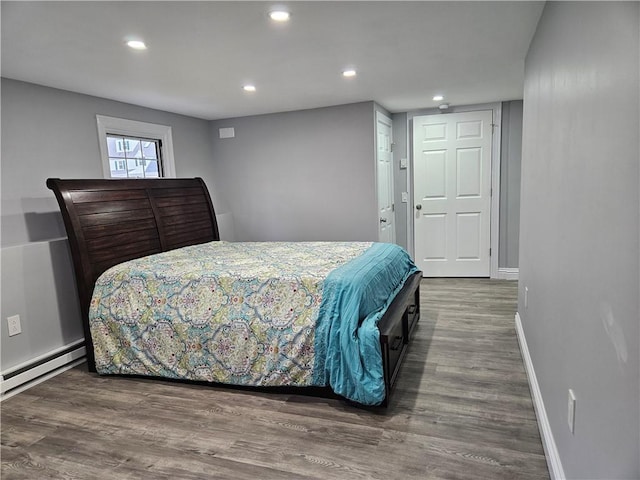 bedroom featuring dark hardwood / wood-style flooring and baseboard heating