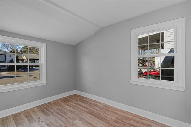 empty room with lofted ceiling and wood-type flooring