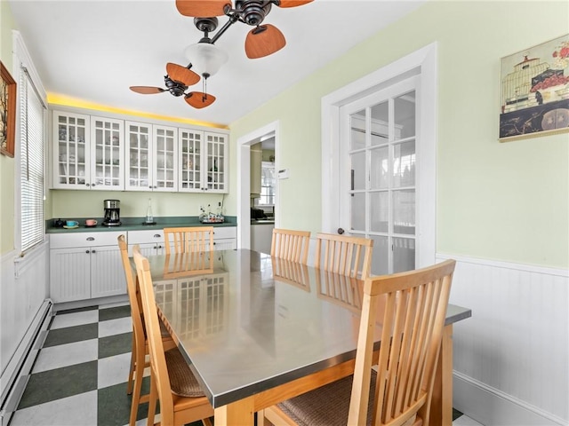 dining area featuring baseboard heating and ceiling fan