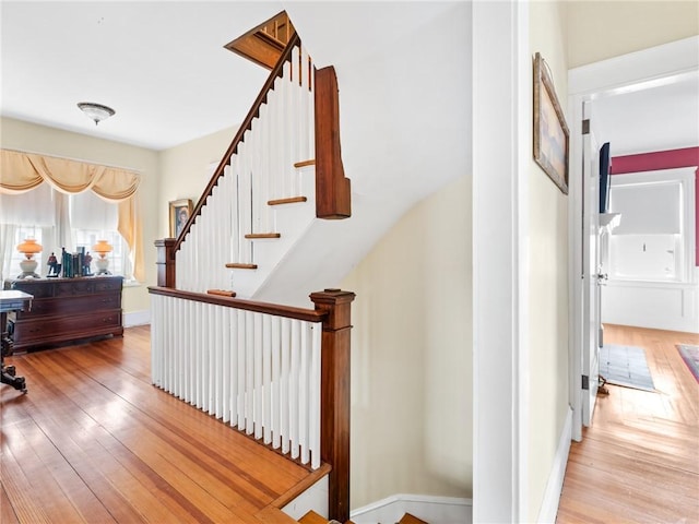 stairs featuring hardwood / wood-style flooring