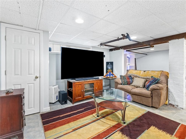 living room with a paneled ceiling