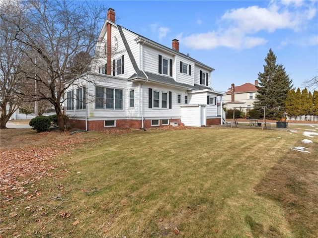 rear view of house with a yard