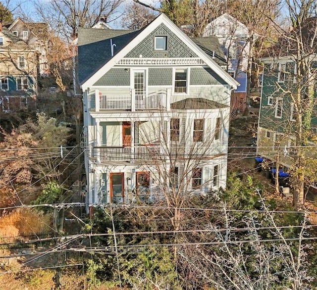 back of property featuring a balcony