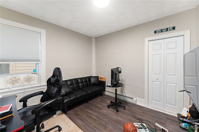 office area featuring a baseboard heating unit and dark hardwood / wood-style flooring