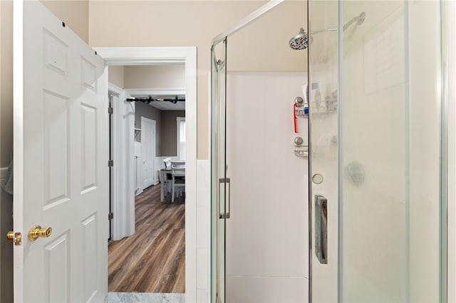 bathroom with walk in shower and wood-type flooring