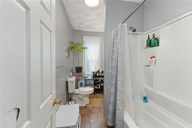 bathroom featuring tile patterned flooring, shower / bath combination with curtain, and toilet