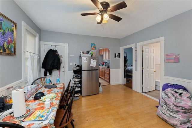 dining room with light hardwood / wood-style floors and ceiling fan