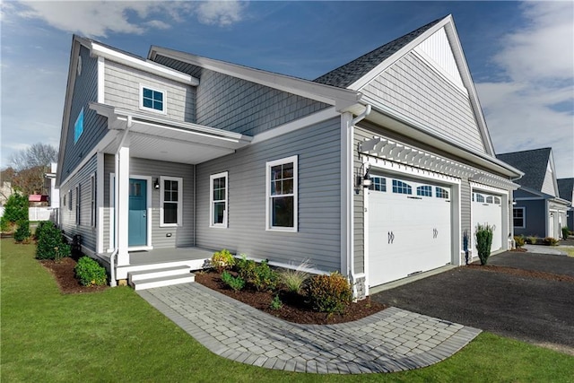 view of front facade with a garage and a front lawn