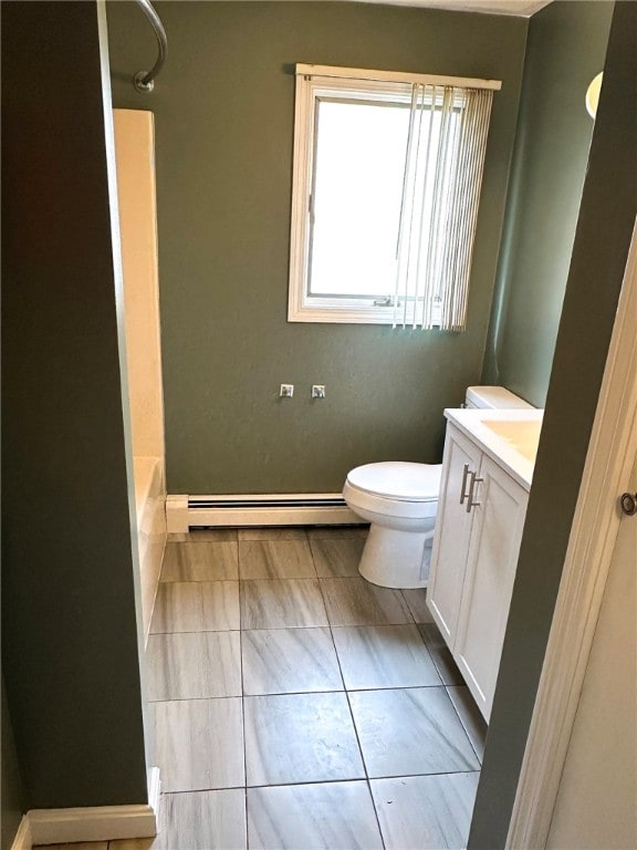 bathroom featuring shower / bathing tub combination, toilet, a baseboard heating unit, vanity, and tile patterned flooring