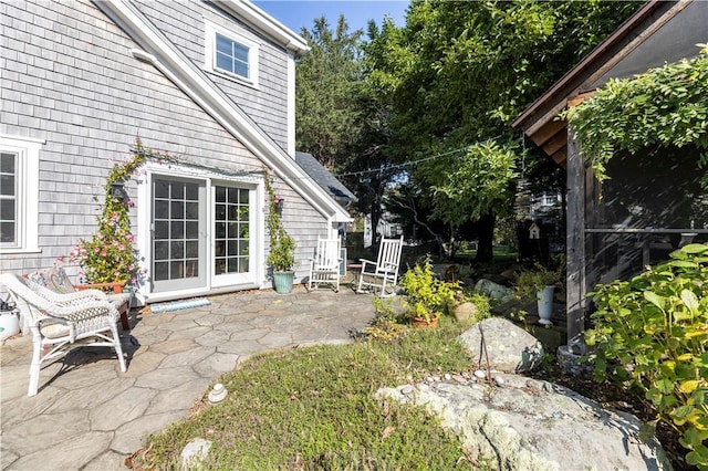 view of yard featuring a patio and french doors