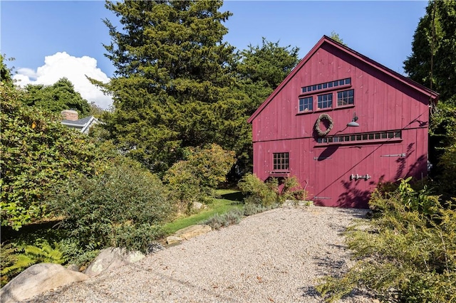 view of home's exterior with an outbuilding