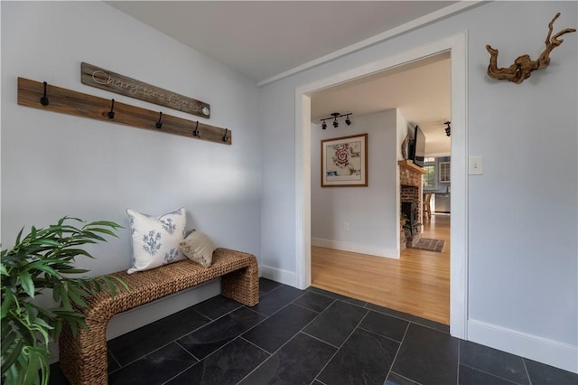 mudroom with dark tile patterned flooring