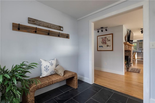 mudroom featuring dark hardwood / wood-style flooring and track lighting