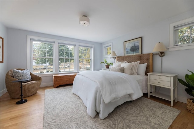 bedroom featuring multiple windows and light hardwood / wood-style floors