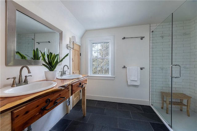 bathroom with tile patterned floors, vanity, and a shower with door