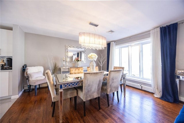 dining space with a notable chandelier and dark wood-type flooring