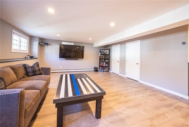 living room with a baseboard radiator and light hardwood / wood-style floors