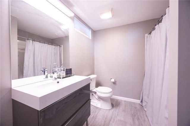 bathroom featuring hardwood / wood-style flooring, vanity, and toilet