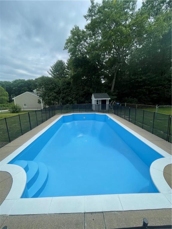 view of pool featuring a storage shed