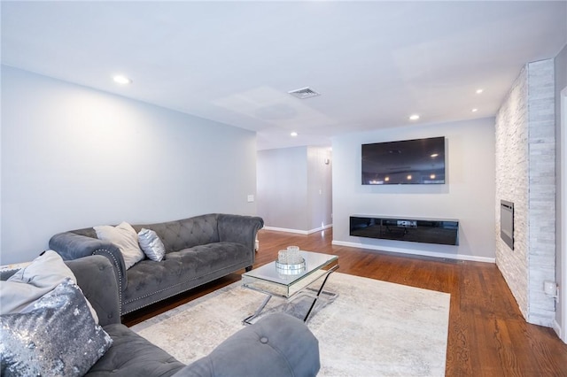 living room with a fireplace and dark hardwood / wood-style floors