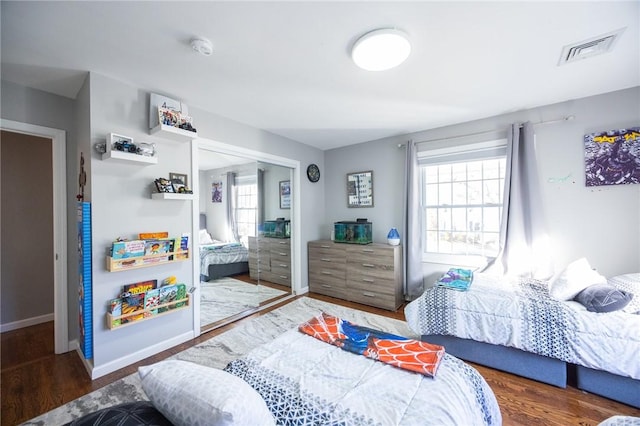 bedroom featuring dark hardwood / wood-style flooring and a closet