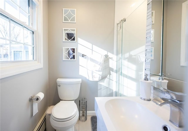 bathroom with toilet, an enclosed shower, and sink