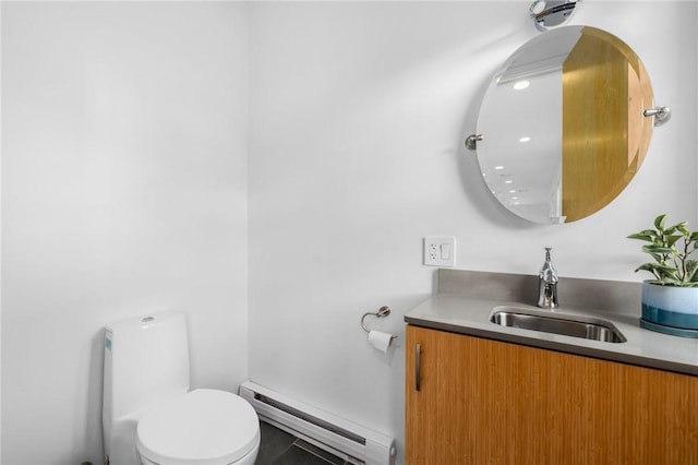 bathroom featuring baseboard heating, vanity, and toilet