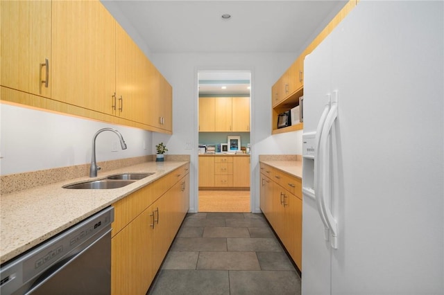 kitchen with sink, white refrigerator with ice dispenser, light stone countertops, light brown cabinetry, and stainless steel dishwasher