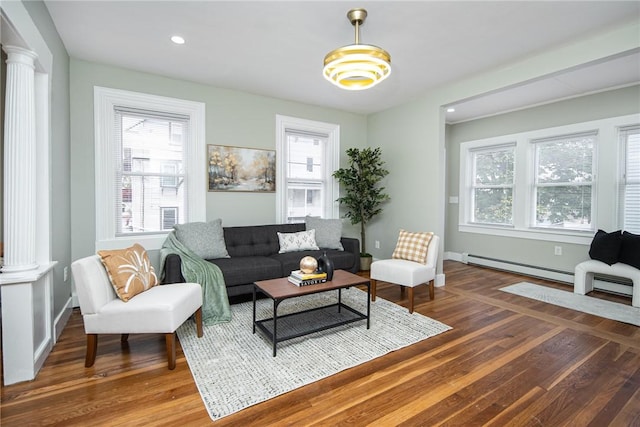 living room with dark hardwood / wood-style floors and ornate columns