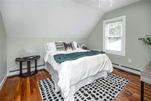 bedroom with a baseboard heating unit, dark wood-type flooring, and vaulted ceiling