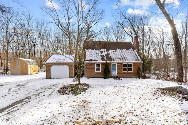 view of front of home featuring a storage shed and a garage