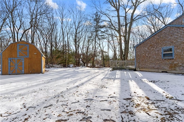 yard layered in snow with an outdoor structure