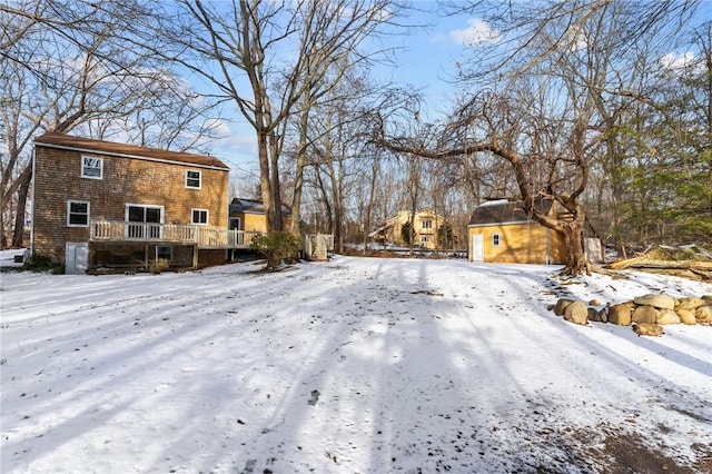 yard covered in snow with a wooden deck