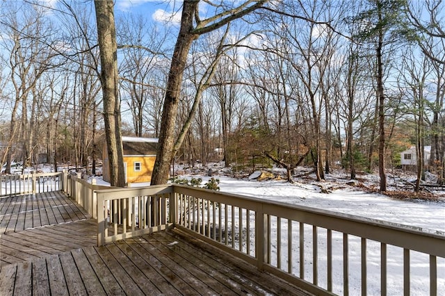 snow covered deck featuring a storage unit