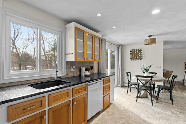 kitchen featuring sink, backsplash, and dishwasher